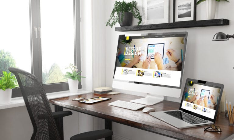 Responsive website design is shown on a computer screen, laptop, tablet, and phone.