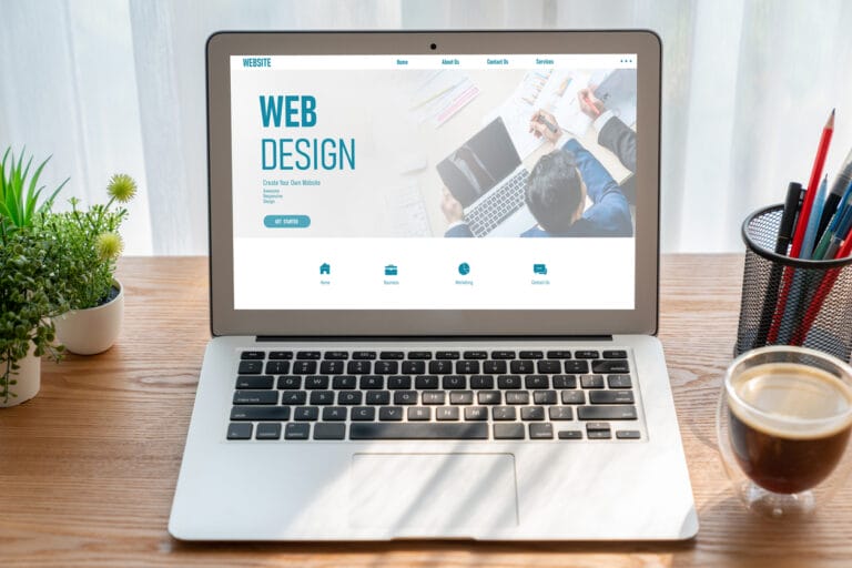 A modish template for an enterprise website displayed on a laptop on an office table