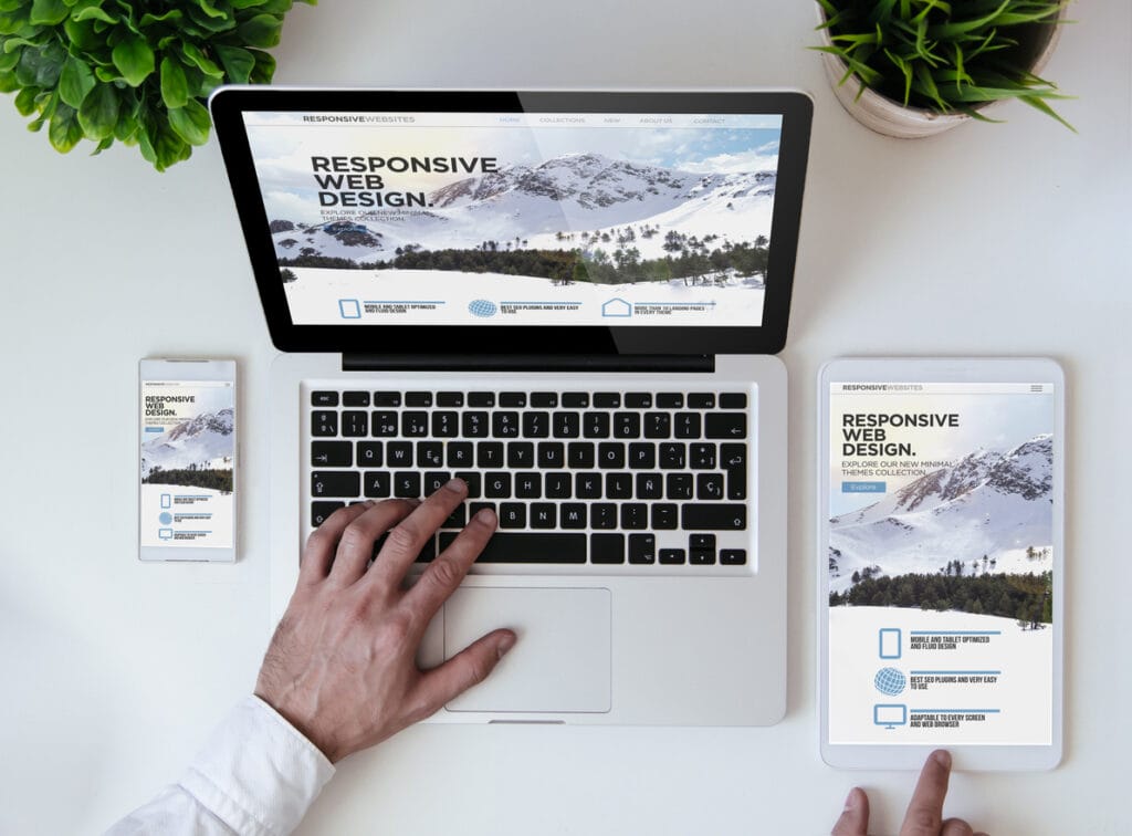An office tabletop with tablet, smartphone, and laptop showing a cool responsive design website resulting from smooth editorial workflows